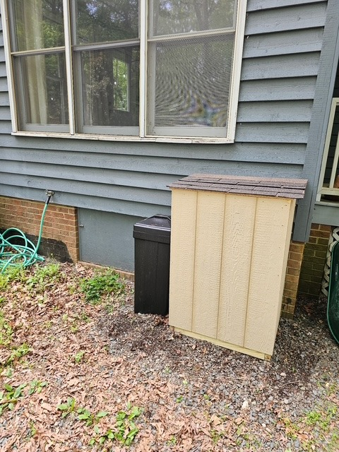 Weatherproof equipment shed built beside the home